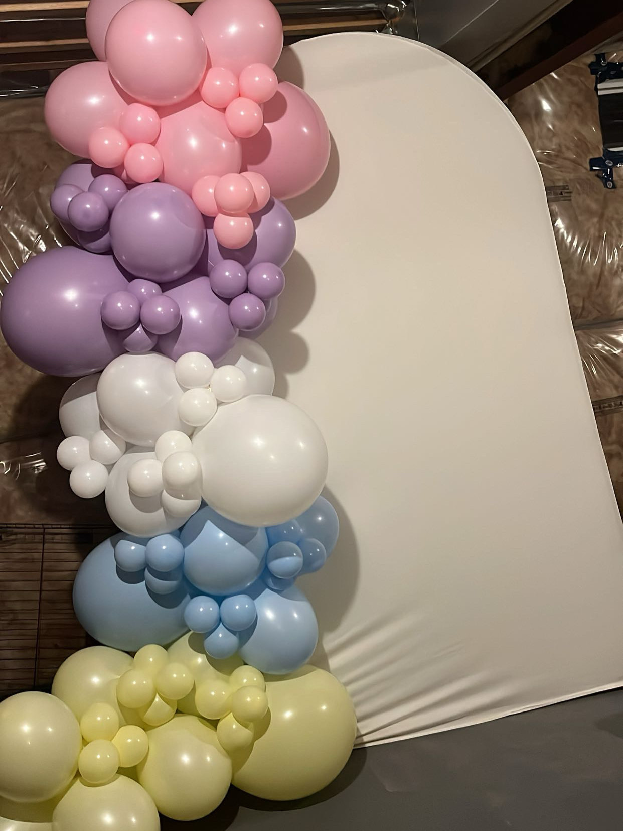 Lush pastel balloon garland with florals by Popgarden Events